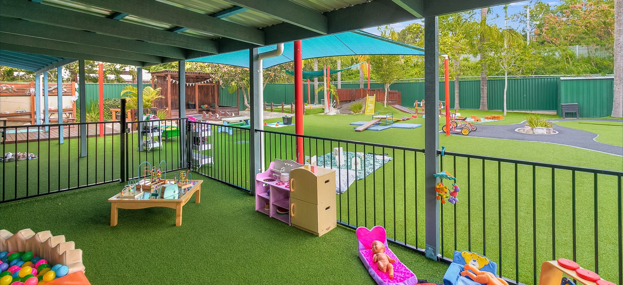 outdoor playground with artificial grass in Tiny Tots Early Learning