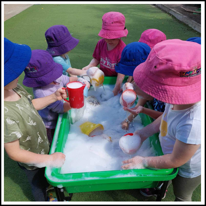 preschool kids playing bubbles in the tub